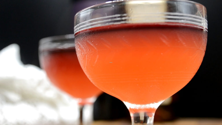 A layered cocktail in an old-fashioned glass