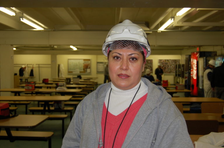 Cargill woman in hardhat stands in breakroom